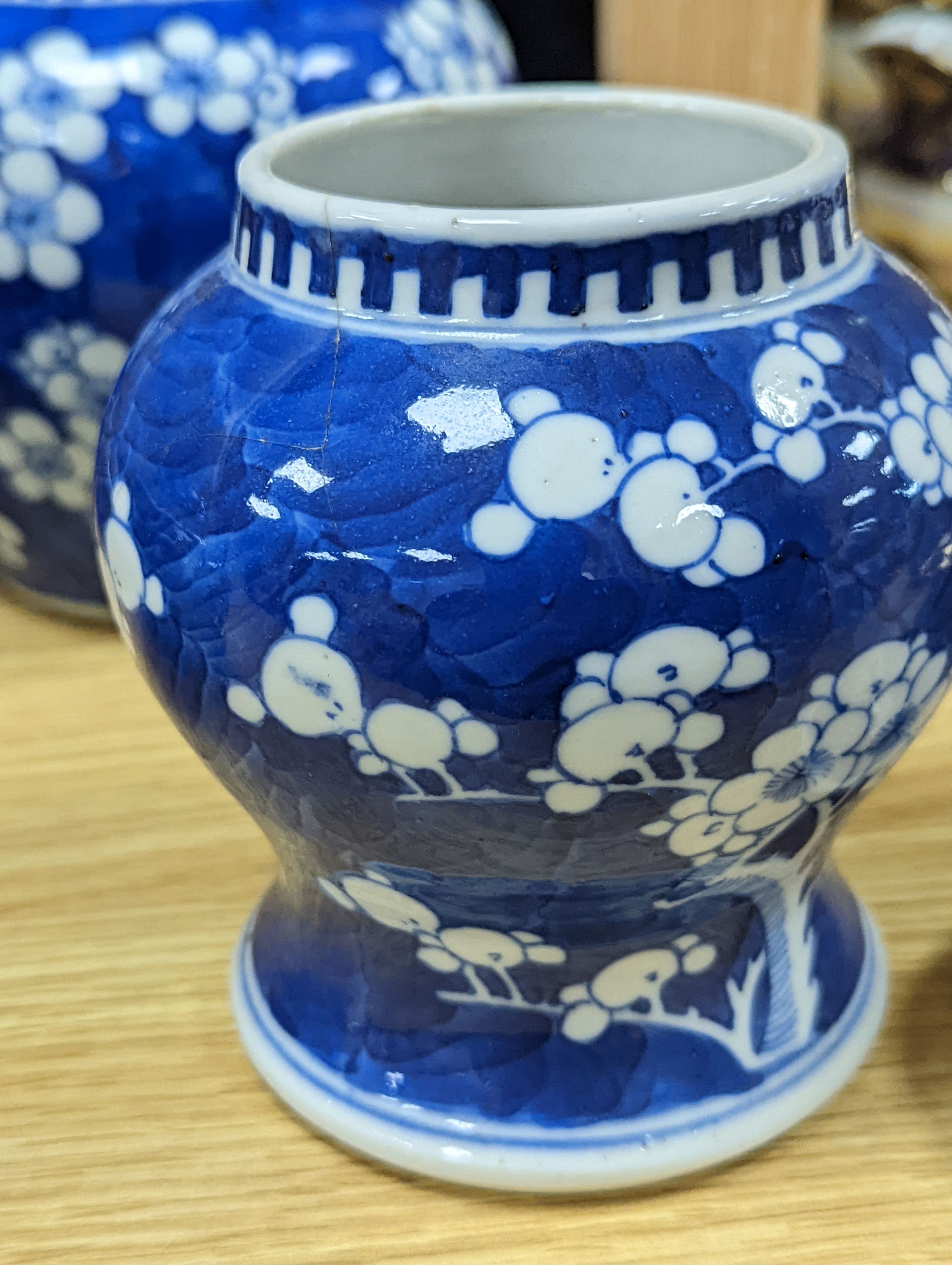 Three Chinese blue and white prunus decorated jars and covers, 19th/20th century, with four character marks 18cm